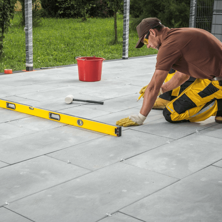 Professional tile installers performing tile floor maintenance